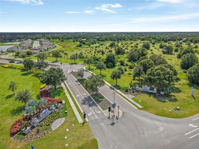 an aerial view of a house with a yard basket ball court and outdoor seating