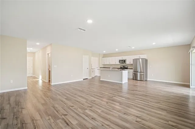 a view of kitchen dining table chairs microwave and cabinets