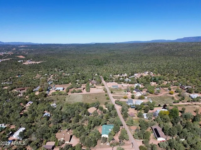 an aerial view of a house with a yard swimming pool and outdoor seating