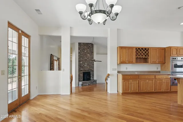 a large kitchen with lots of counter space wooden floor and stainless steel appliances