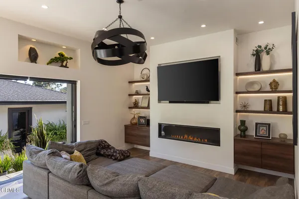a living room with furniture a fireplace and a flat screen tv