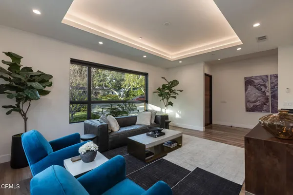 a living room with furniture and a potted plant