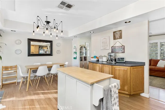 a view of a dining room with furniture and chandelier