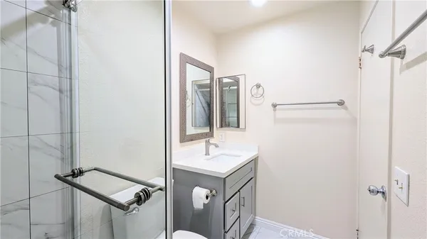 a bathroom with a sink a mirror and shower