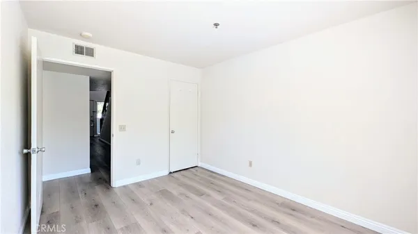 a view of a room with wooden floor
