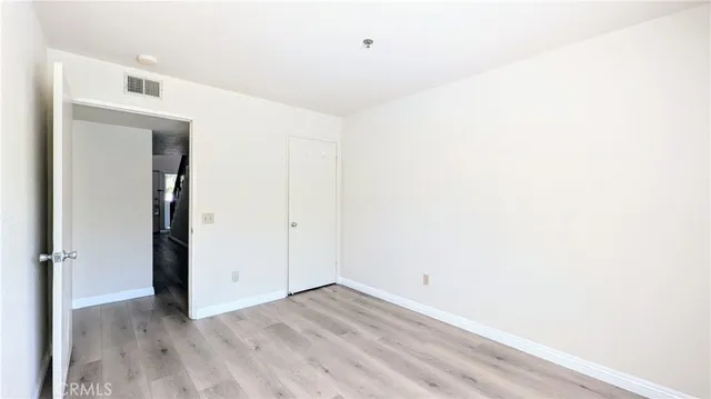 a view of a room with wooden floor
