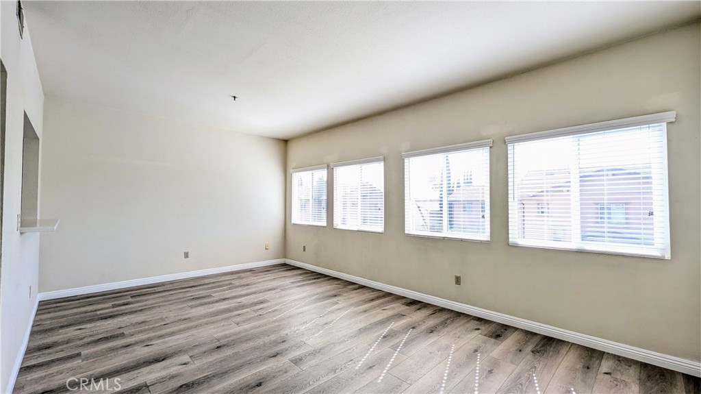 801 South 2nd Street, Unit 3 Alhambra, CA 91801 - Photo 5 of 22 a view of an empty room with wooden floor and a window