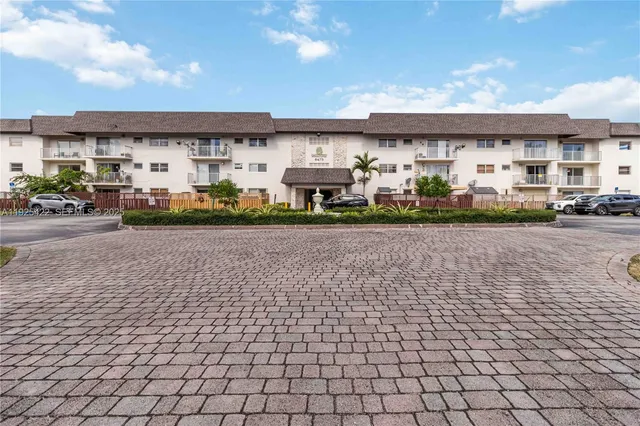 a view of building with cars parked