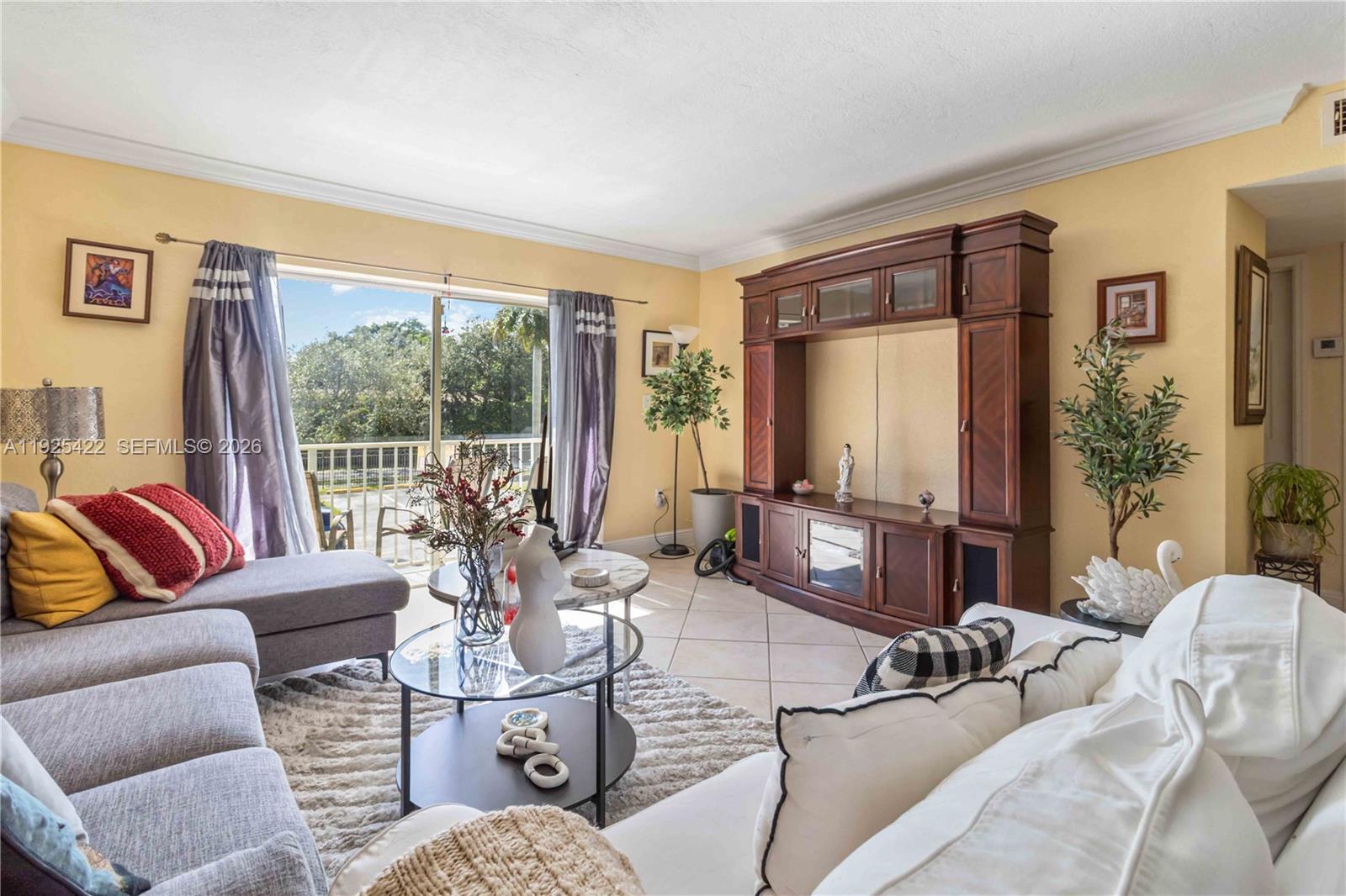 8475 Southwest 94th Street, Unit 217E Miami, FL 33156 - Photo 2 of 21 a living room with furniture and a large window