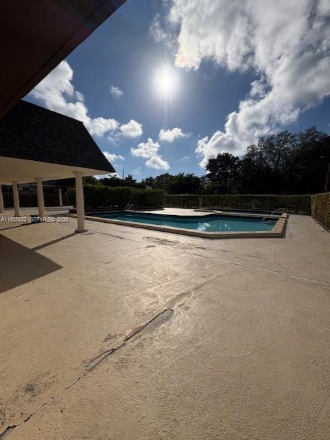 8475 Southwest 94th Street, Unit 217E Miami, FL 33156 - Photo 21 of 21 a view of swimming pool with an outdoor space and seating area