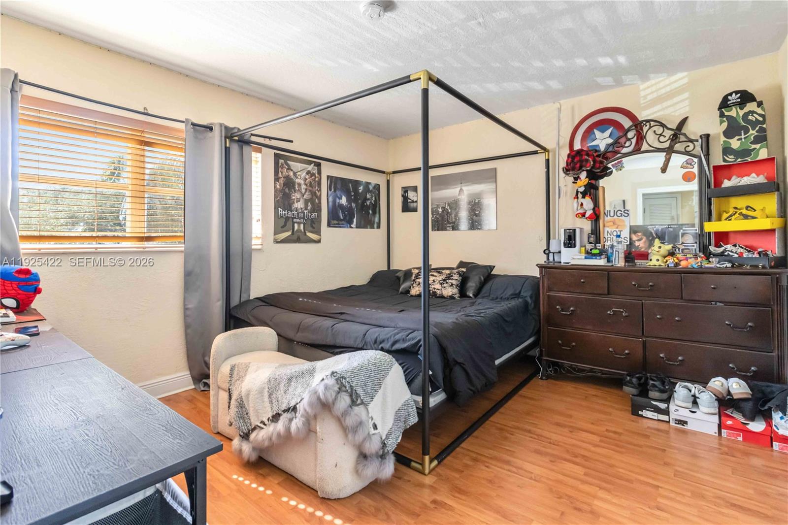 8475 Southwest 94th Street, Unit 217E Miami, FL 33156 - Photo 6 of 21 a bedroom with a bed and wooden floor