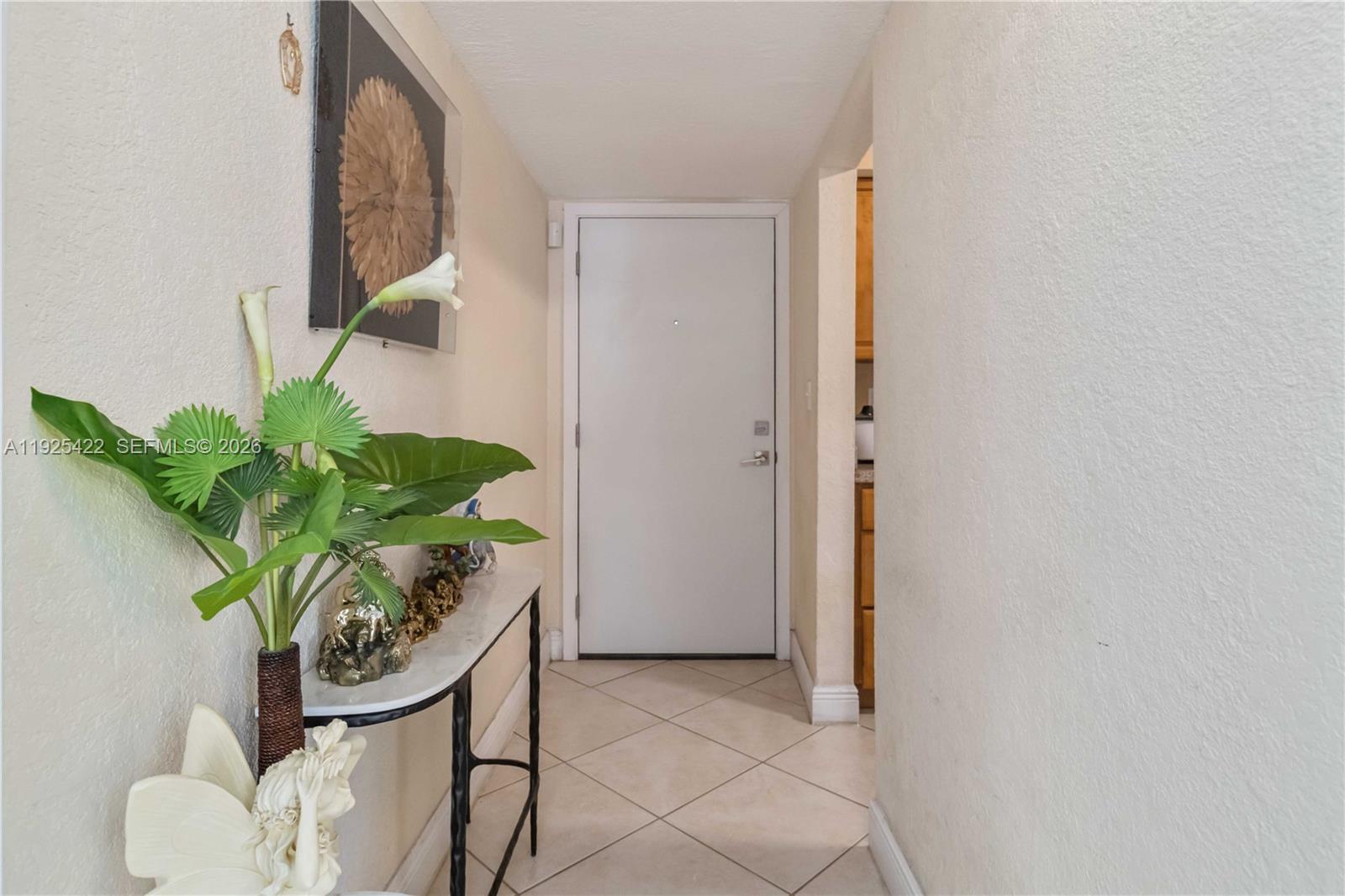 8475 Southwest 94th Street, Unit 217E Miami, FL 33156 - Photo 7 of 21 a potted plant sitting in front of a bathroom