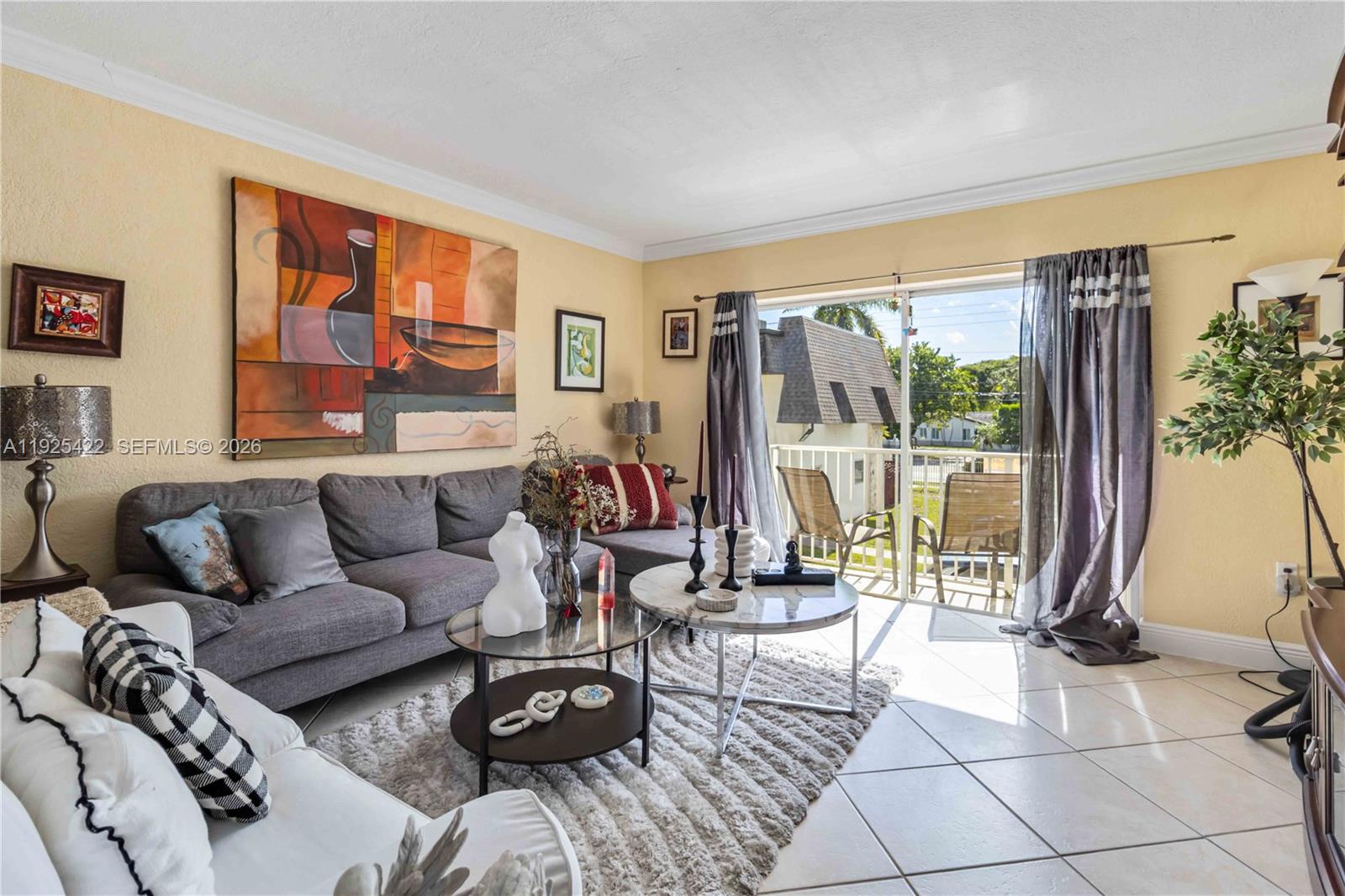 8475 Southwest 94th Street, Unit 217E Miami, FL 33156 - Photo 9 of 21 a living room with furniture and a floor to ceiling window