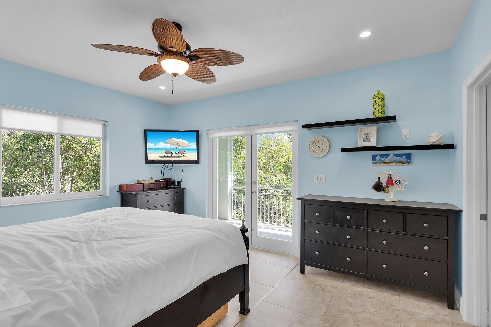 1019 Snapper Lane Key Largo, FL 33037 - Photo 14 of 49 a bedroom with a bed and a chandelier