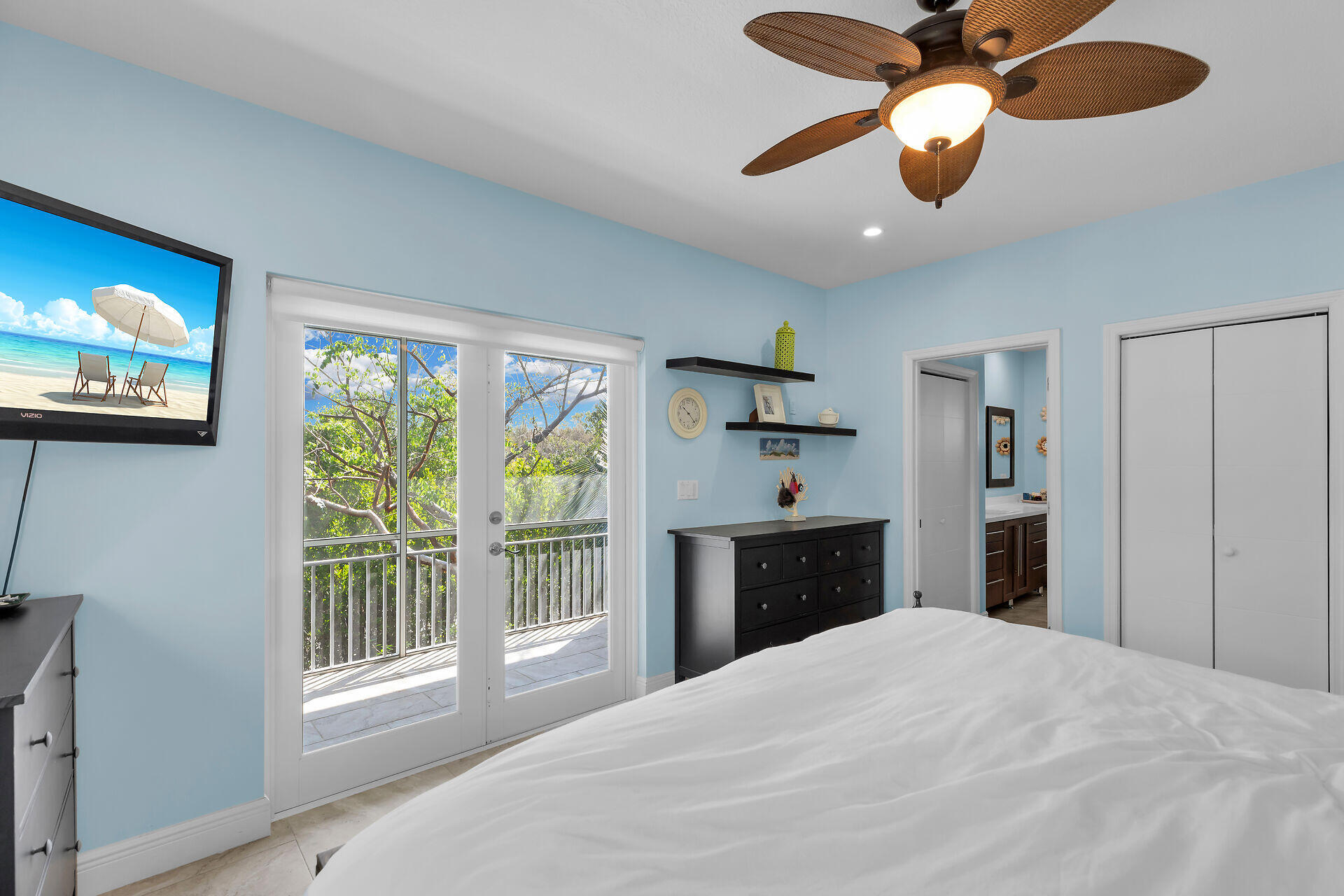 1019 Snapper Lane Key Largo, FL 33037 - Photo 15 of 49 a bedroom with a bed and a chandelier