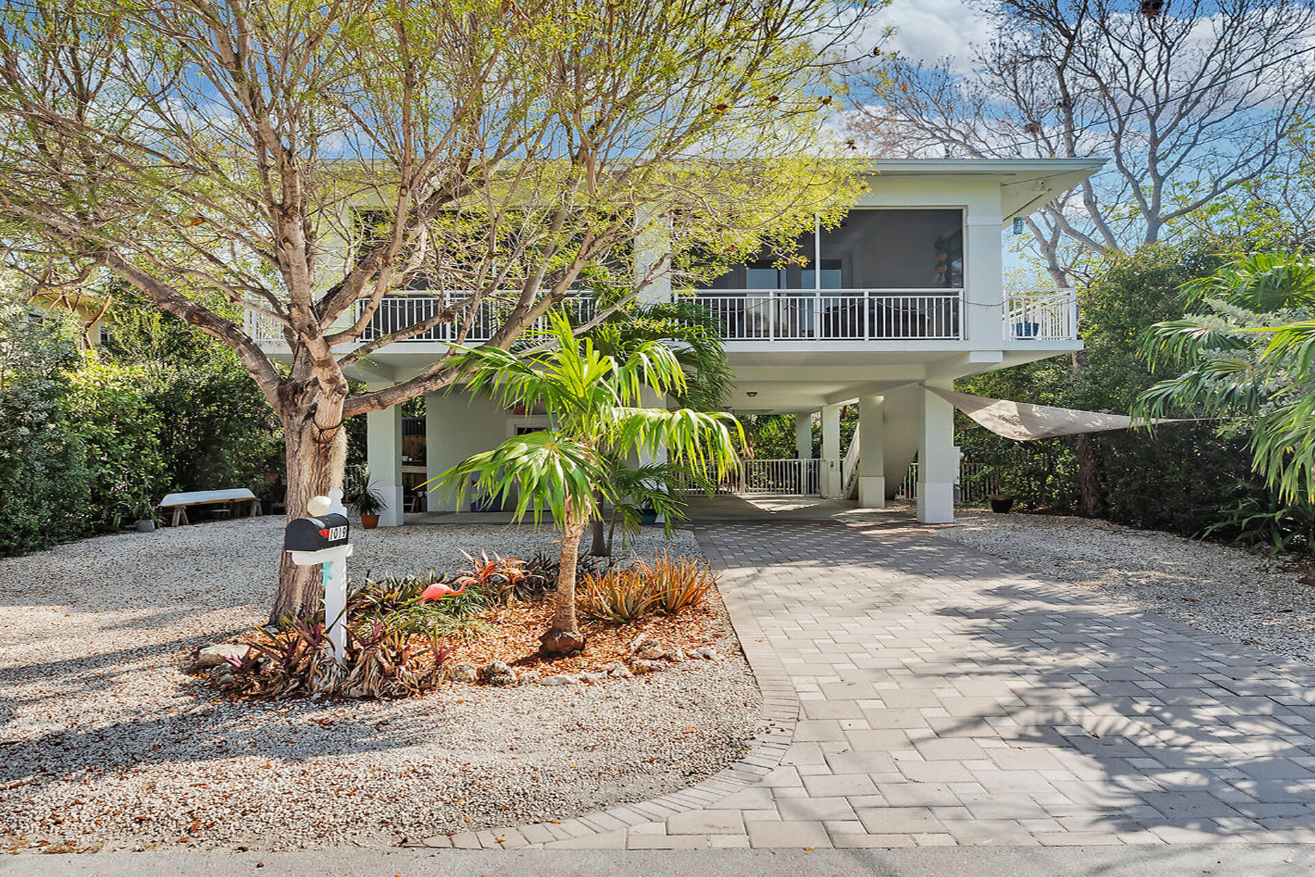 1019 Snapper Lane Key Largo, FL 33037 - Photo 2 of 49 a view of a house with a yard and tree s