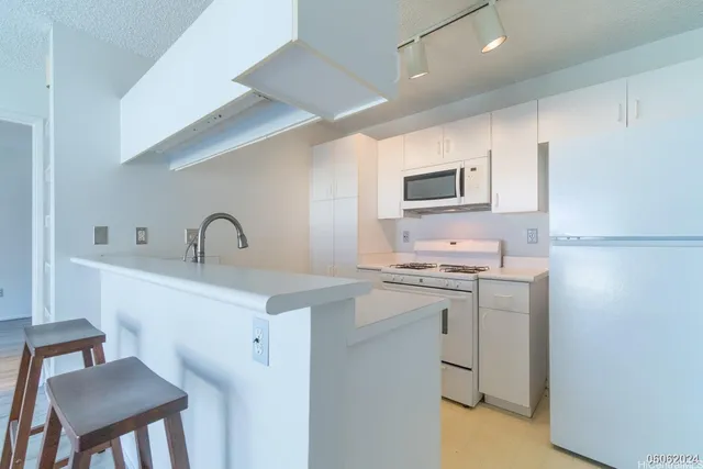 a kitchen with a sink cabinets and appliances