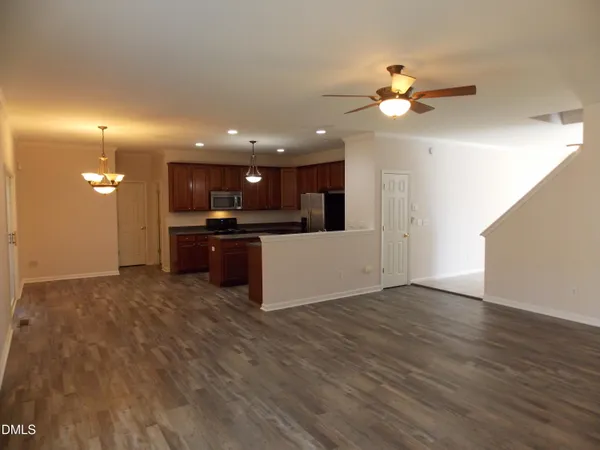 a view of a kitchen with a sink and a refrigerator