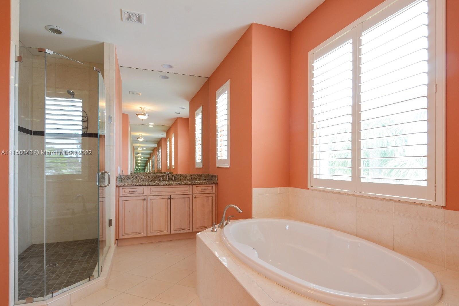 1960 Northeast 33rd Street Lighthouse Point, FL 33064 - Photo 13 of 24 a spacious bathroom with sink shower and bathtub