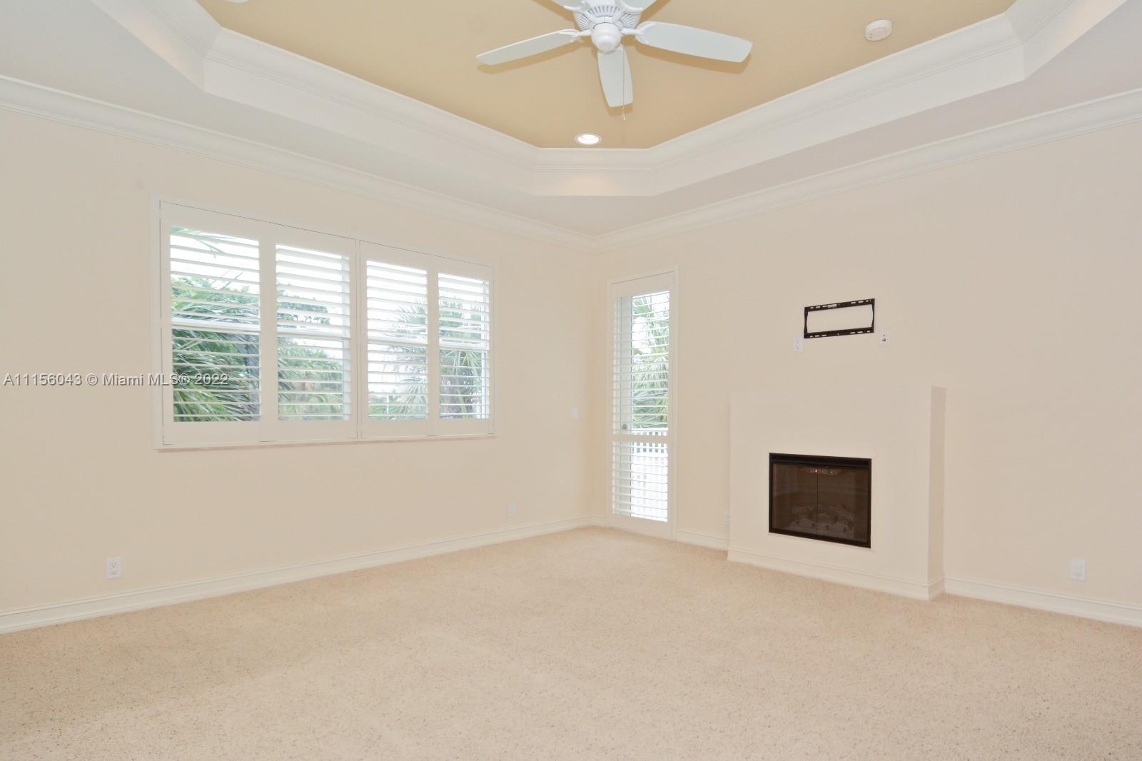 1960 Northeast 33rd Street Lighthouse Point, FL 33064 - Photo 18 of 24 an empty room with windows and fireplace