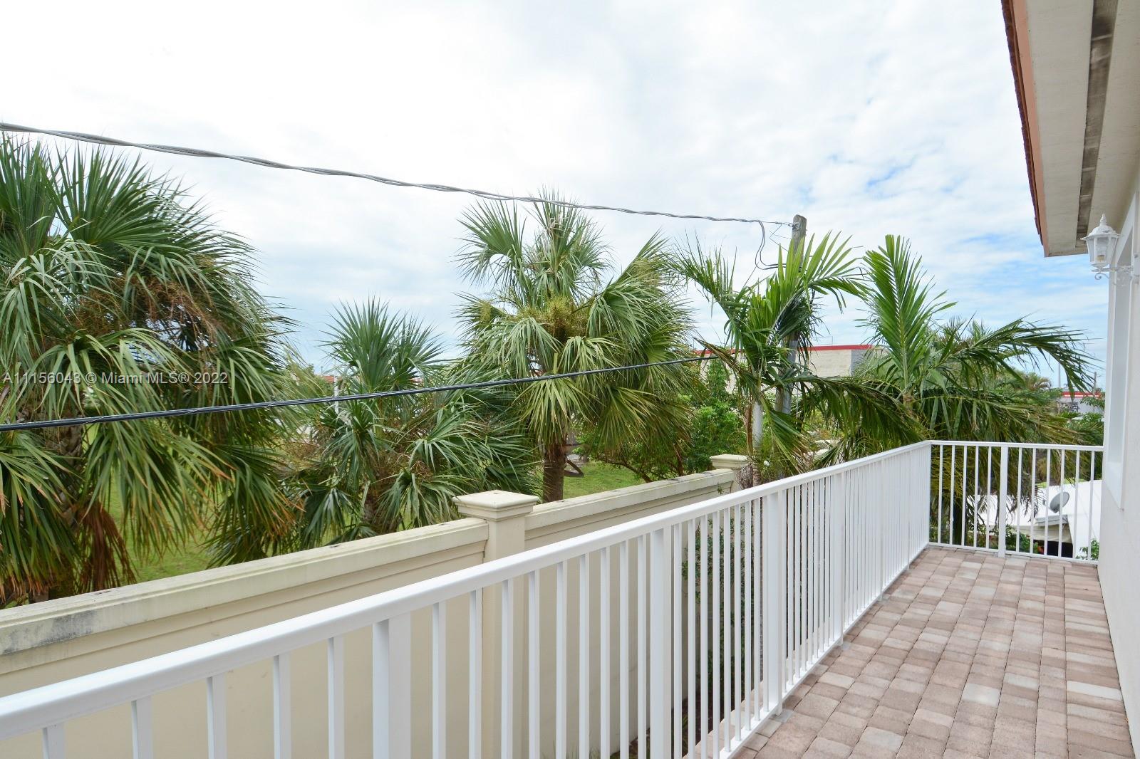 1960 Northeast 33rd Street Lighthouse Point, FL 33064 - Photo 22 of 24 a view of a balcony with a plant