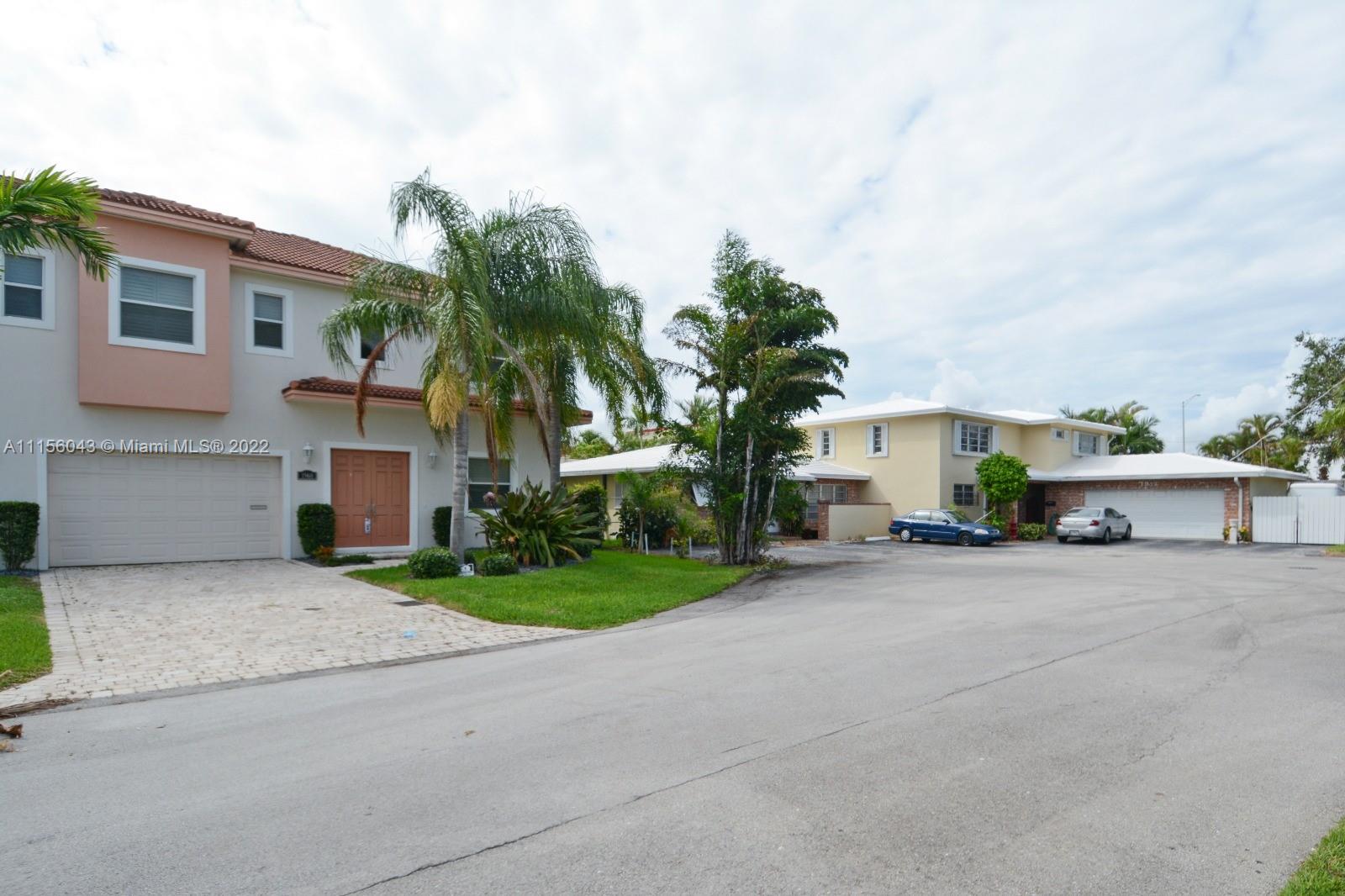 1960 Northeast 33rd Street Lighthouse Point, FL 33064 - Photo 23 of 24 front view of a house with a yard and a garage