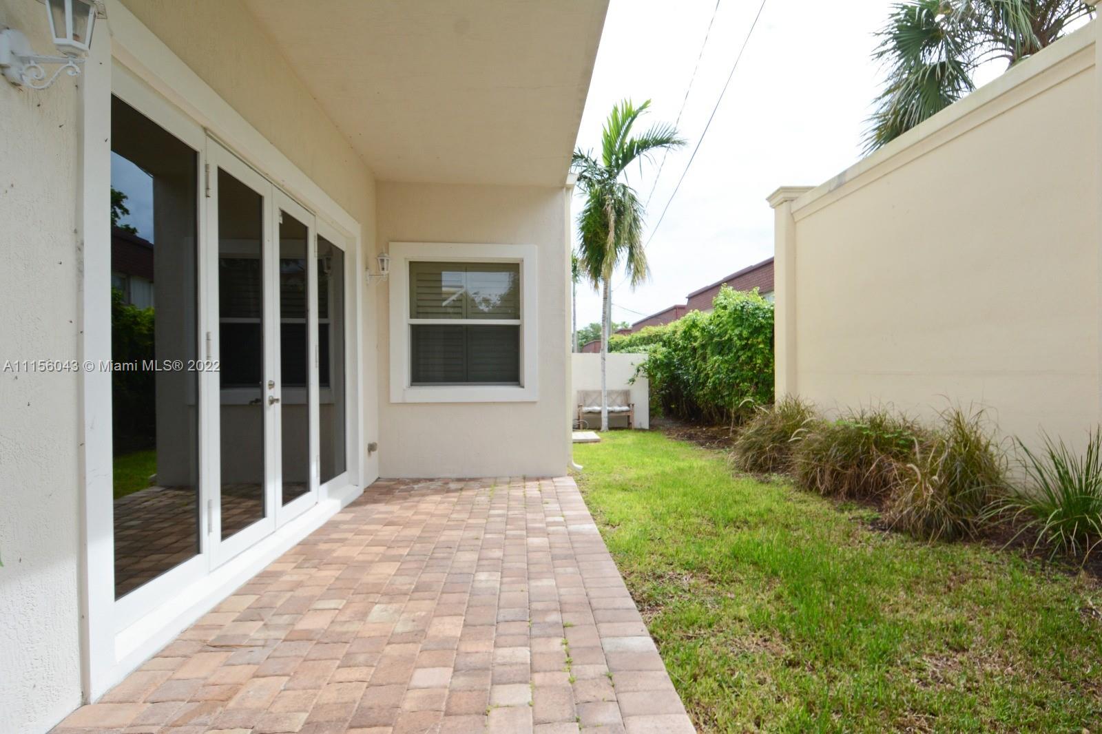 1960 Northeast 33rd Street Lighthouse Point, FL 33064 - Photo 24 of 24 a front view of a house with a yard and potted plants