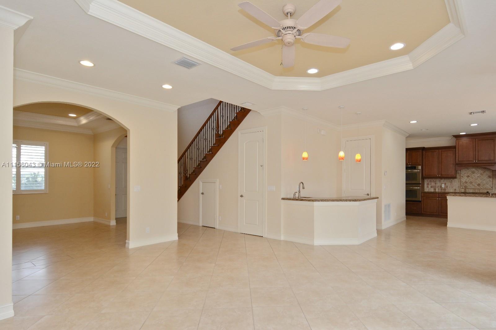 1960 Northeast 33rd Street Lighthouse Point, FL 33064 - Photo 10 of 24 a view of a hallway with kitchen and chandelier