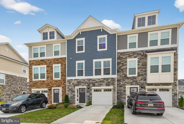 a car parked in front of a brick house with a yard