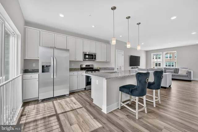 a kitchen with granite countertop a counter space stainless steel appliances and cabinets