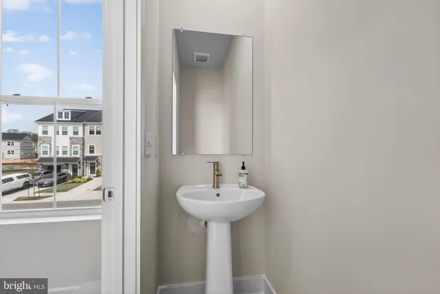 a bathroom with a sink a mirror and a toilet