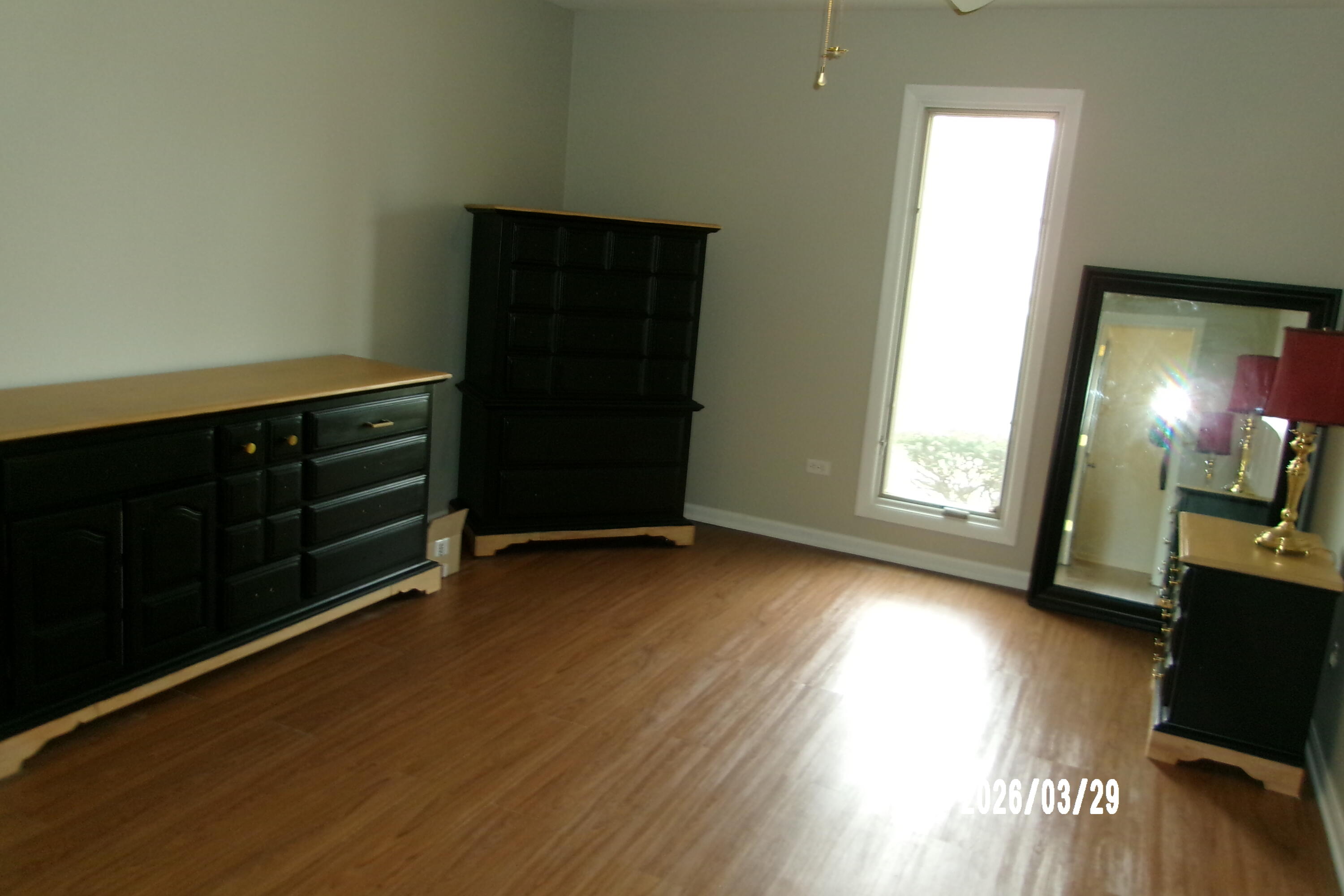 405 Old Stone Road, Unit E2 Munster, IN 46321 - Photo 9 of 20 a view of an empty room with wooden floor and a window