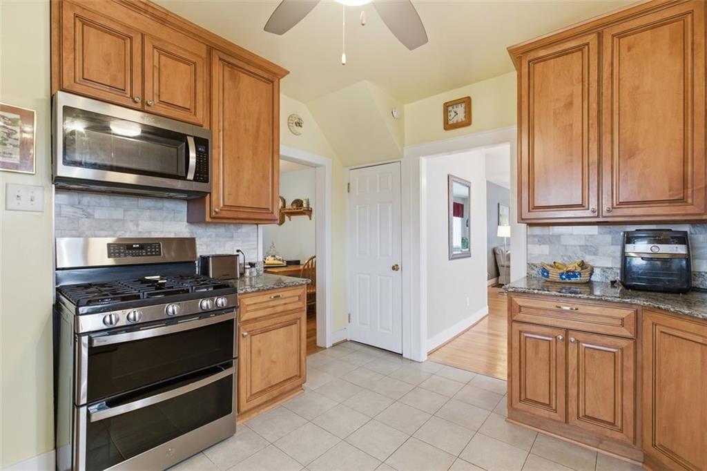 1505 4th Street Monongahela, PA 15063 - Photo 11 of 40 a kitchen with granite countertop a stove top oven microwave and cabinets