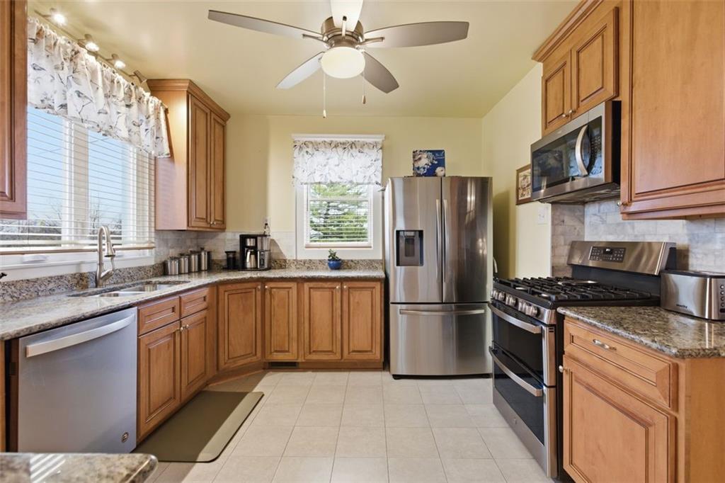 1505 4th Street Monongahela, PA 15063 - Photo 13 of 40 a kitchen with stainless steel appliances granite countertop a refrigerator stove a sink and dishwasher