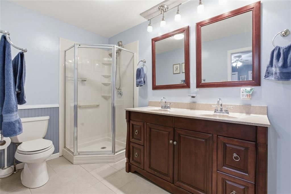 1505 4th Street Monongahela, PA 15063 - Photo 29 of 40 a bathroom with a toilet a sink a mirror and a shower