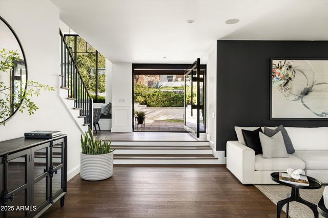 a view of a bedroom with furniture and wooden floor
