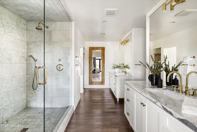 a bathroom with a granite countertop sink mirror and shower