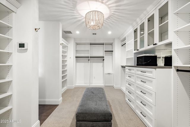 a view of a hallway with a cabinet and a living room