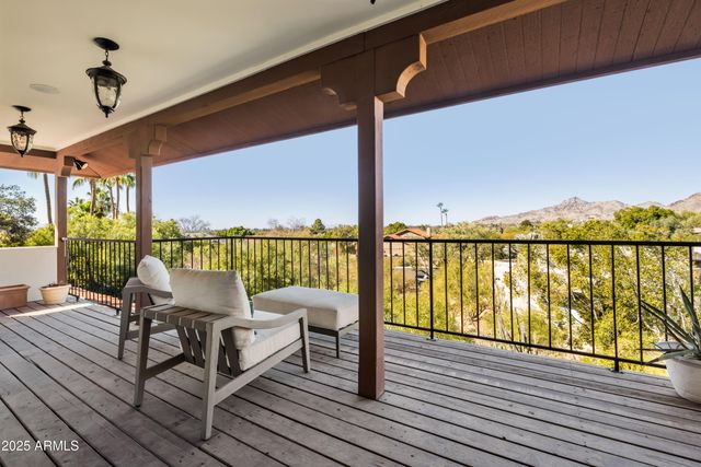 a balcony with wooden floor outdoor seating and ocean view