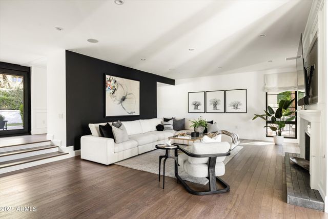a living room with furniture and wooden floor