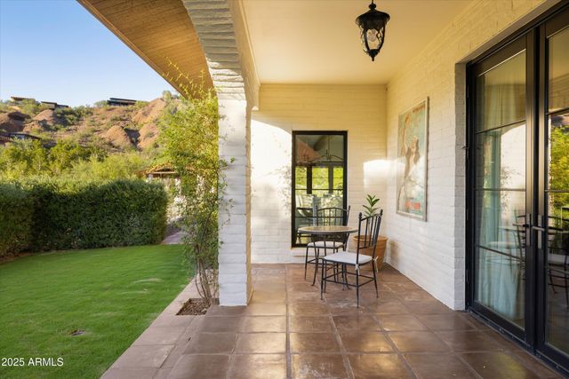 a view of two chairs in the patio