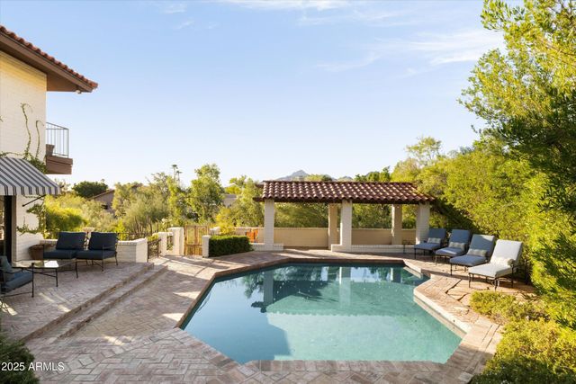 swimming pool view with a seating space