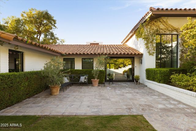 a view of a house with backyard porch and sitting area