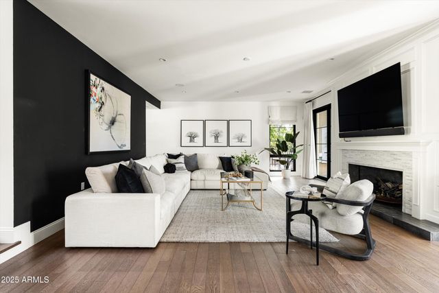 a living room with furniture fireplace and flat screen tv