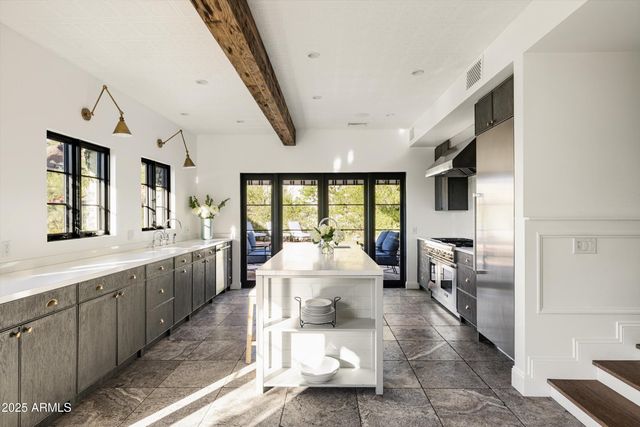 a large white room with a large window and furniture