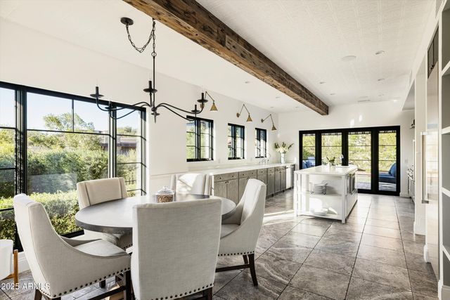 a living room with furniture and large windows