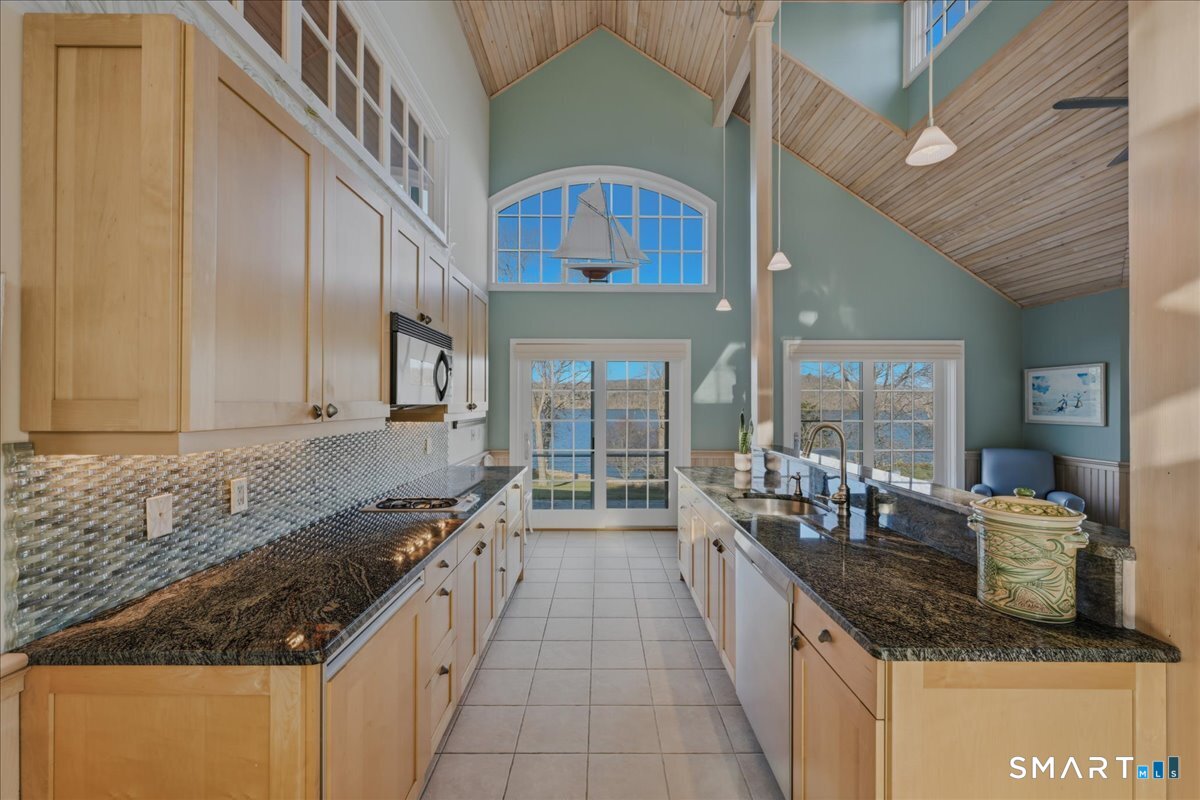 175 River Road Essex, CT 06426 - Photo 31 of 40 a large kitchen with granite countertop a sink and a stove