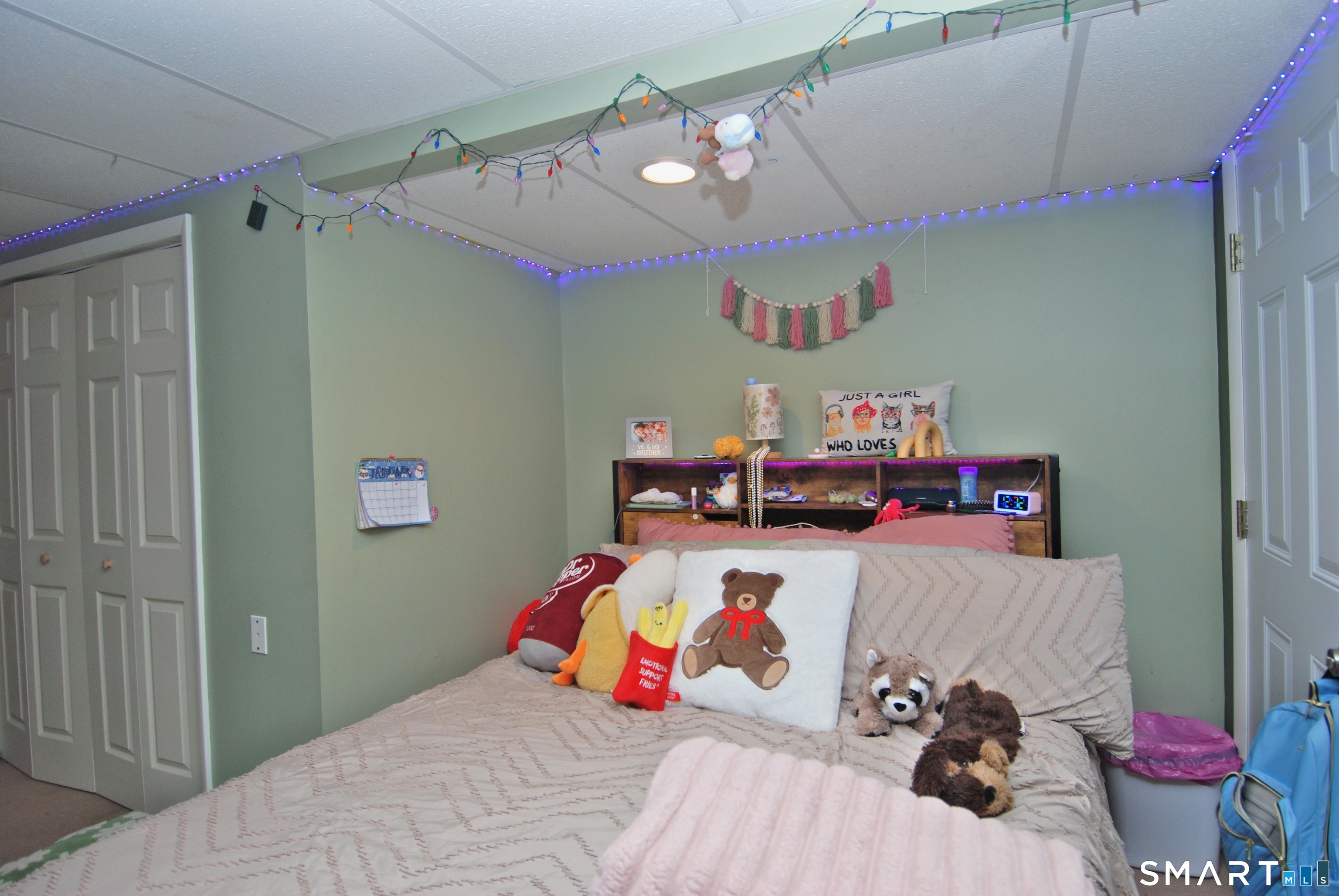 321 Greens Loop, Unit 321 Cheshire, CT 06410 - Photo 18 of 24 a room with a bed and a chandelier