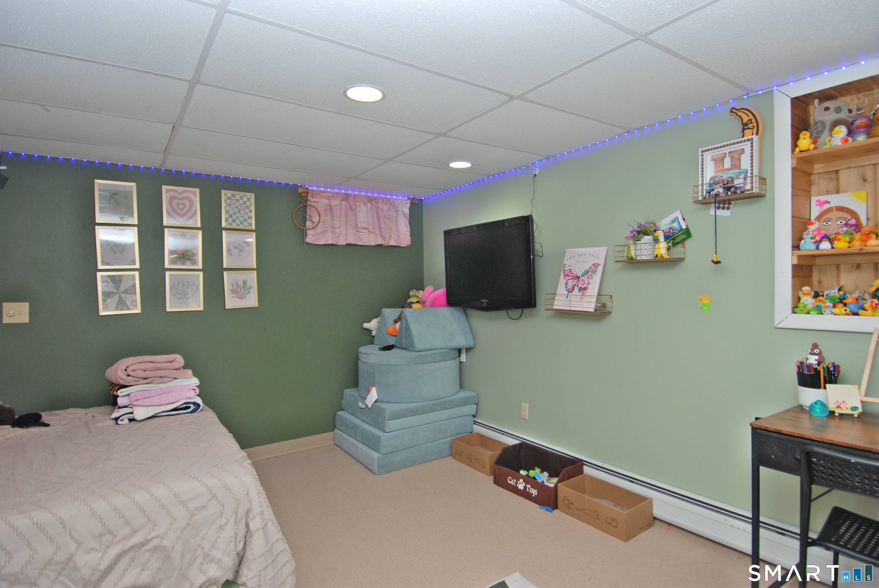 321 Greens Loop, Unit 321 Cheshire, CT 06410 - Photo 19 of 24 a room with toys and a flat screen tv