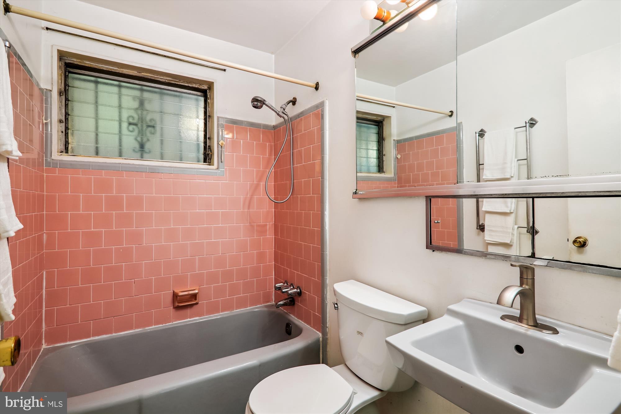 9507 Adelphi Road Silver Spring, MD 20903 - Photo 21 of 41 a bathroom with a sink toilet a mirror and bathtub